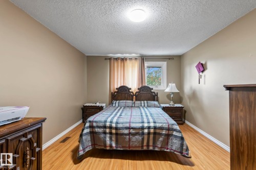 Wood-finish flooring, neutral wall tones, and a window with natural light - 716 Clareview Rd Nw, Edmonton, AB 
