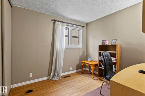 Neutral tone walls, wood-finish flooring, and a single window - 716 Clareview Rd Nw, Edmonton, AB 