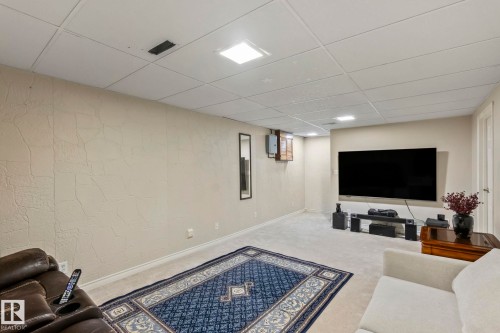 Recessed lighting, drop ceiling, textured wall finish, and wall-mounted television - 716 Clareview Rd Nw, Edmonton, AB 