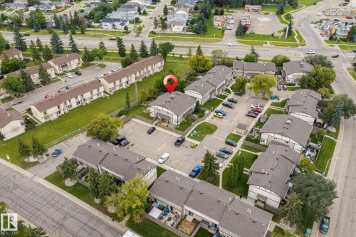 Multi-unit residential property featuring multiple structures, paved parking areas, and mature landscaping - 716 Clareview Rd Nw, Edmonton, AB 