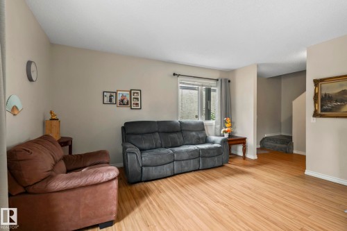 Wood-finish flooring, neutral wall tones, and a window with natural light - 716 Clareview Rd Nw, Edmonton, AB 