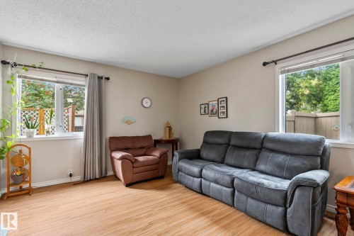 Recessed windows with natural light, neutral wall colors, wood-finish flooring, and a textured ceiling - 716 Clareview Rd Nw, Edmonton, AB 