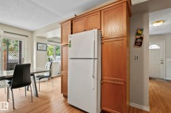 Built-in wood-finish cabinetry, wood-finish flooring, and a white sliding glass door - 