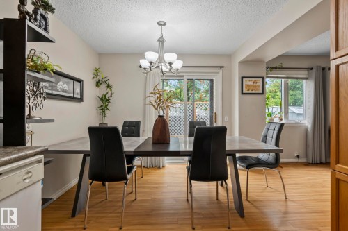 Wood-finish flooring, sliding glass door, and a built-in shelving unit - 716 Clareview Rd Nw, Edmonton, AB 