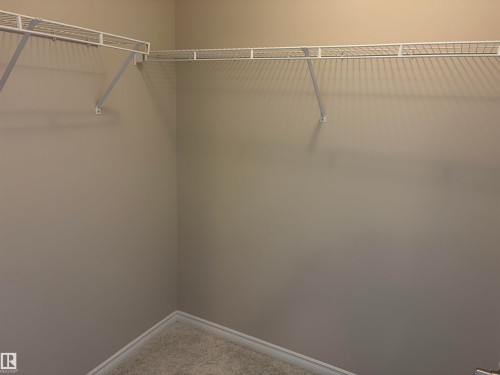 Wire shelving system with a corner configuration, offering storage solutions - #100 13825 155 Av Nw, Edmonton, AB 