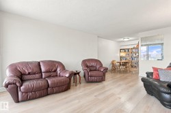 Light-toned wood-finish flooring extends throughout the space, complemented by neutral wall finishes - 