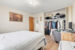 Wood-finish flooring, built-in shelving, and a flush-mount ceiling light - 