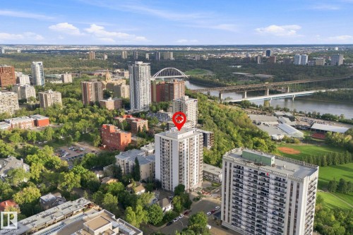 High-rise building situated within an urban landscape, featuring river access and surrounding green spaces - #1507 9835 113 St Nw, Edmonton, AB 