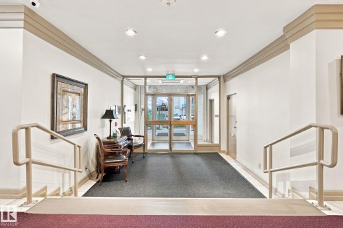 Entryway featuring glass double doors, recessed lighting, and a textured area rug - #1507 9835 113 St Nw, Edmonton, AB 