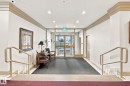 Entryway featuring glass double doors, recessed lighting, and a textured area rug - #1507 9835 113 St Nw, Edmonton, AB 