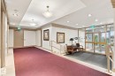 Recessed lighting, drop ceiling, wall sconces, large glass entry, and handrailed staircase - #1507 9835 113 St Nw, Edmonton, AB 