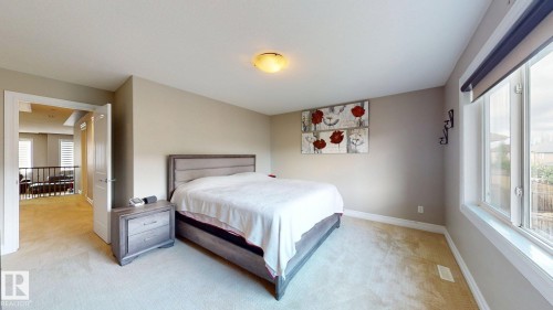 Carpeted flooring throughout, neutral wall paint, white trim, and a window with blinds - 1232 Cunningham Drive Sw, Edmonton, AB 