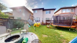 Manicured lawn with a paver patio and fire pit - 
