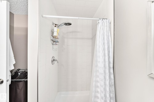 Tile shower surround with a fixed showerhead and single handle control - #418 279 Suder Greens Dr Nw, Edmonton, AB 