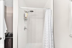 Tile shower surround with a fixed showerhead and single handle control - 