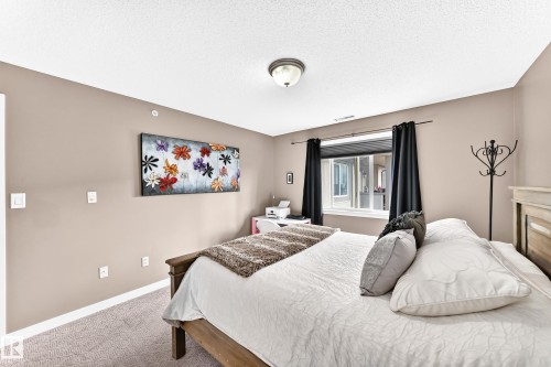 Neutral-toned walls complement a textured carpet flooring - #418 279 Suder Greens Dr Nw, Edmonton, AB 
