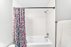 White tiled shower surround with a built-in tub - 