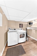 Wood-finish flooring, drop ceiling, and wall-mounted shelving units - 