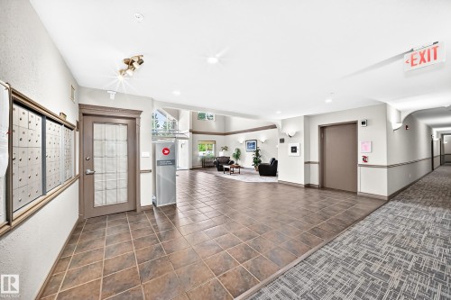 Tiled flooring, overhead lighting fixtures, and a glass-paneled door - #418 279 Suder Greens Dr Nw, Edmonton, AB 