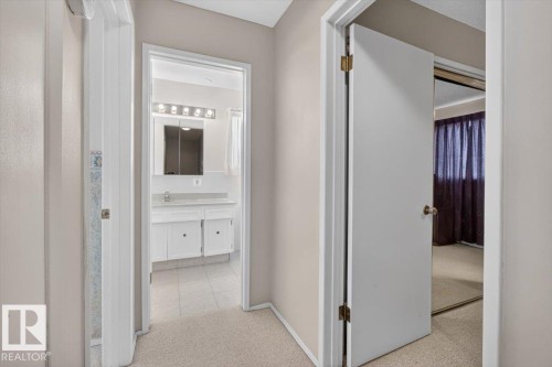 Hallway featuring light-toned carpet flooring - 4027 74 Street Nw, Edmonton, AB - Indoor Photo Showing Other Room