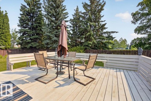 Expansive outdoor deck featuring light-colored decking, integrated bench seating, and privacy fencing - 4027 74 Street Nw, Edmonton, AB - Outdoor With Deck Patio Veranda