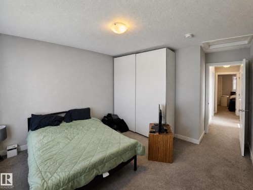 Plush carpet flooring, neutral wall tones, and overhead lighting - 13309 128 Street Nw, Edmonton, AB 