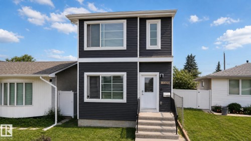 Two-story exterior with horizontal dark siding and white trim - 13309 128 Street Nw, Edmonton, AB 