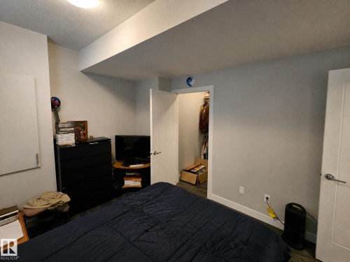 Recessed ceiling light, white trim, wood-finish flooring, and a built-in closet - 13309 128 Street Nw, Edmonton, AB 