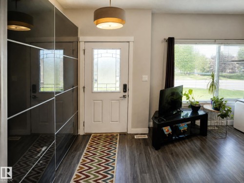 Spa-inspired primary bathroom with frameless glass enclosure, wood-finish flooring, and natural light from multiple windows - 13309 128 Street Nw, Edmonton, AB 