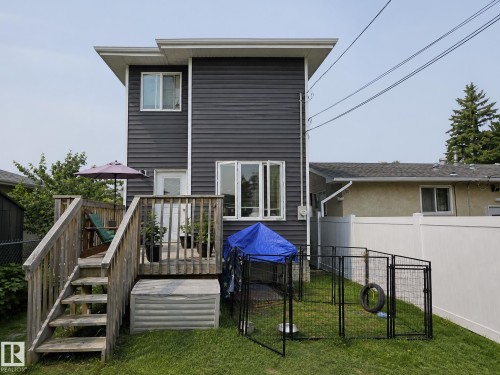 Exterior featuring dark gray horizontal siding and a multi-level wooden deck - 13309 128 Street Nw, Edmonton, AB 