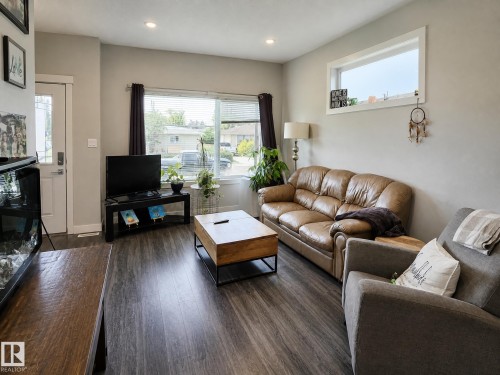 Recessed lighting, wood-finish flooring, white trim, and a window with blinds - 13309 128 Street Nw, Edmonton, AB 