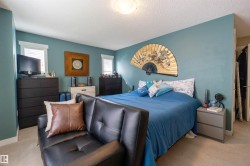 Recessed windows with blinds, light blue wall paint, light-toned carpet flooring, and a flush mount ceiling light fixture - 