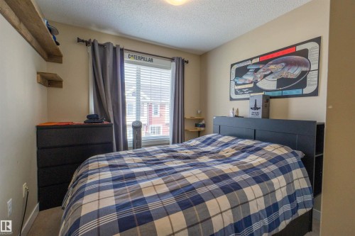 Wall-to-wall carpeting and a window with blinds and drapes - #75 8315 180 Av Nw, Edmonton, AB 