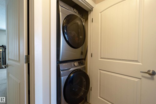 White paneled door with brushed nickel hardware - #75 8315 180 Av Nw, Edmonton, AB 