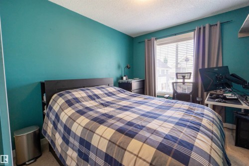 Window with horizontal blinds and drapery rods - #75 8315 180 Av Nw, Edmonton, AB 