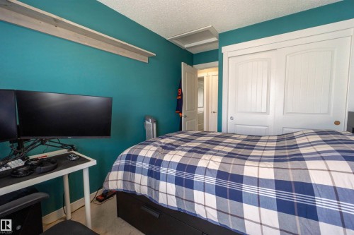 Built-in shelving, two-panel interior doors, and a ceiling hatch - #75 8315 180 Av Nw, Edmonton, AB 