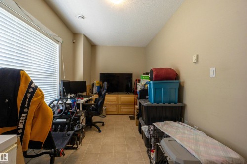 Room featuring light-toned wall paint and a textured ceiling - #75 8315 180 Av Nw, Edmonton, AB 
