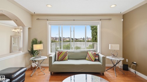 Living space featuring a prominent window offering an expanse of water scenery - 6116 53 Avenue, Beaumont, AB - Indoor Photo Showing Living Room