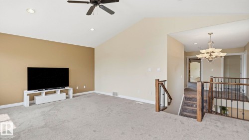 Open-concept upper-level room featuring vaulted ceilings, recessed lighting, and a ceiling fan - 6116 53 Avenue, Beaumont, AB - Indoor
