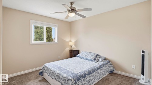 Bedroom featuring a white framed window, neutral wall paint, and gray carpet flooring - 6116 53 Avenue, Beaumont, AB - Indoor Photo Showing Bedroom