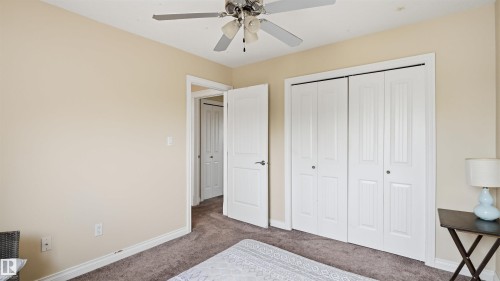 Carpeted interior space featuring neutral wall tones and white trim - 6116 53 Avenue, Beaumont, AB - Indoor Photo Showing Bedroom