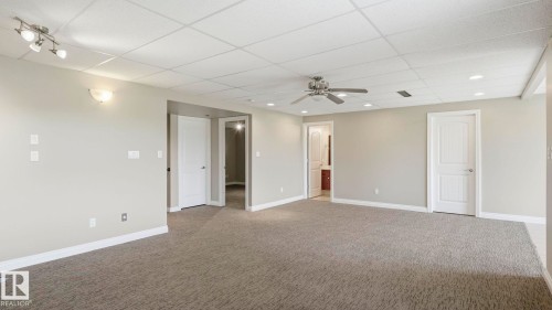 Spacious room with neutral gray walls and patterned gray carpeting - 6116 53 Avenue, Beaumont, AB - Indoor Photo Showing Other Room