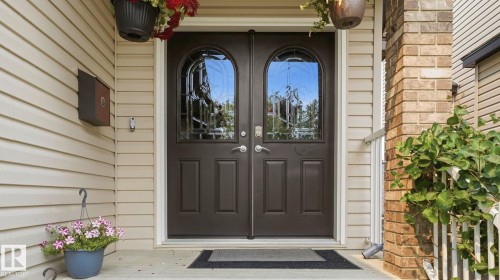 Double entry doors with arched decorative glass inserts - 6116 53 Avenue, Beaumont, AB - Outdoor With Exterior