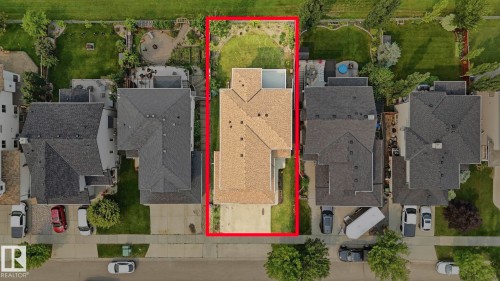 Expansive property featuring a multi-level home with a tan shingle roof - 6116 53 Avenue, Beaumont, AB - 