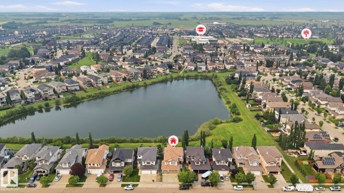Aerial overview showcasing a residential community centered around a prominent lake - 6116 53 Avenue, Beaumont, AB - Outdoor With Body Of Water With View