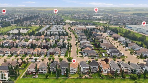 Residential neighborhood featuring detached homes, tree-lined streets, and multiple water features - 6116 53 Avenue, Beaumont, AB - Outdoor With View