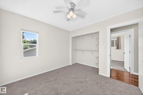 Recessed window, ceiling fan, open closet with wire shelving, and carpet flooring - 12721 117 Street Nw, Edmonton, AB 