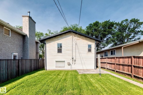 Rear exterior with horizontal siding and a black roof - 12721 117 Street Nw, Edmonton, AB 