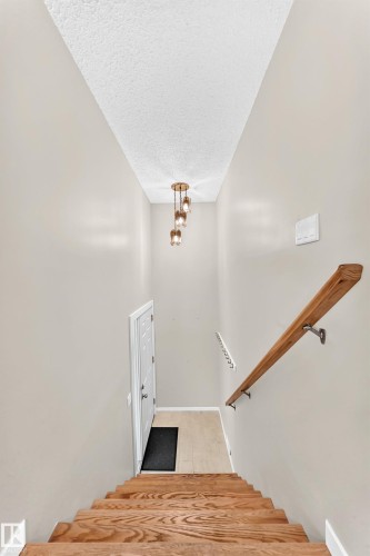 Wood-finish staircase with coordinating wood handrail - 12721 117 Street Nw, Edmonton, AB 