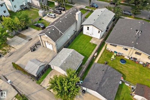 Property featuring multiple structures, a paved drive, and grassy areas - 12721 117 Street Nw, Edmonton, AB 